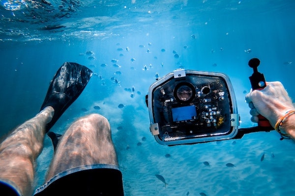 Taucher mit Unterwassergehäuse für Kompaktkamera